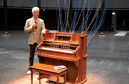 Photo of DB in front of organ